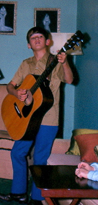 Young Jimmy playing his guitar.